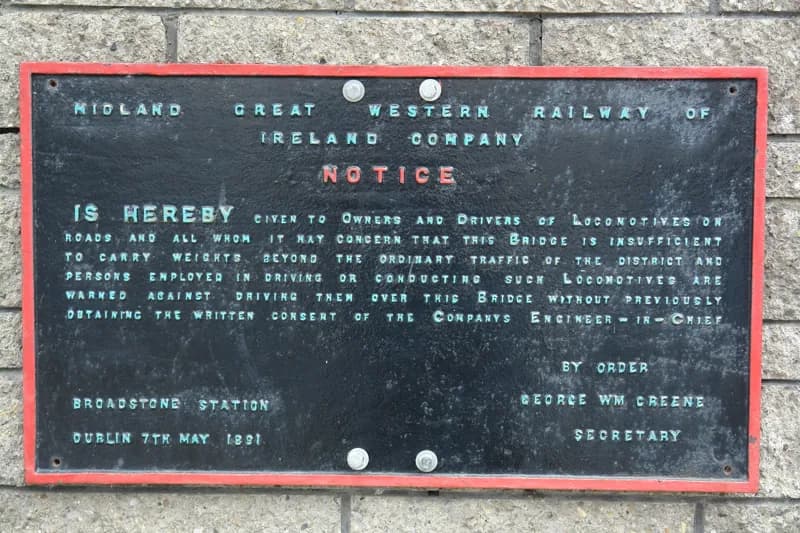 Enamel notice of the Midland Great Western Railway of Ireland Company, black lettering in a red border.